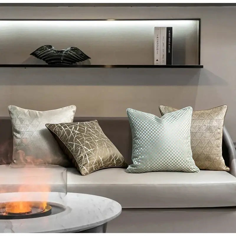 Four decorbites asian landscape painting jacquard pillow covers in metallic silver gold and light blue on a modern sofa