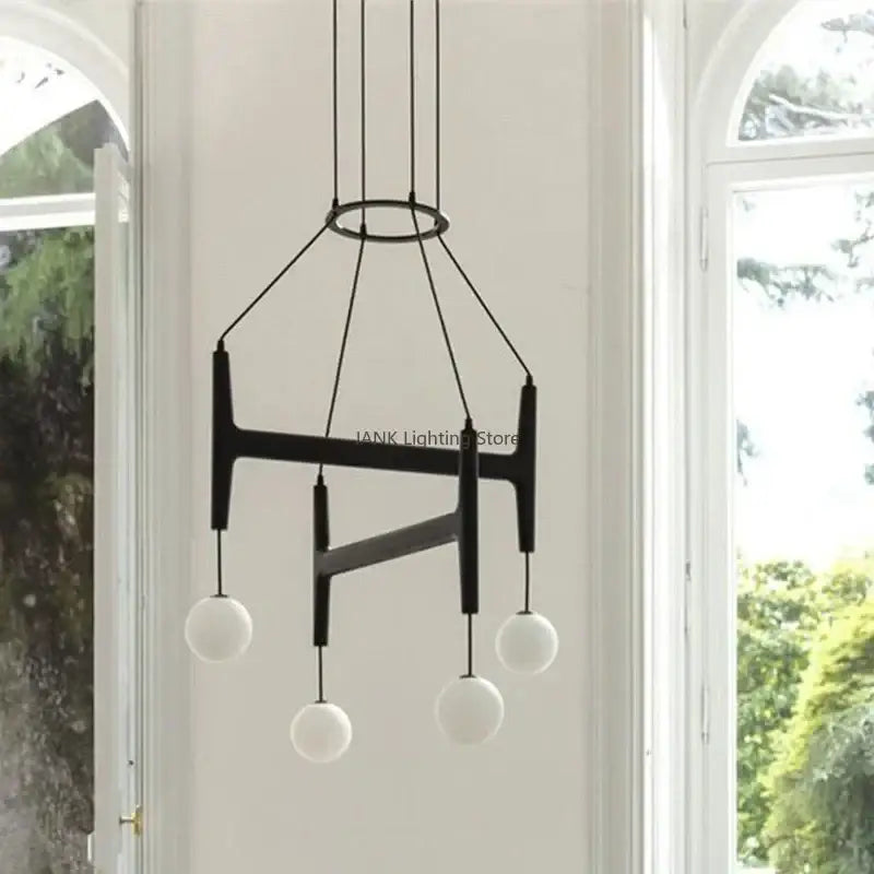 Black modern pendant light with geometric metal frame and four frosted glass globes decorbites astra wood pendant