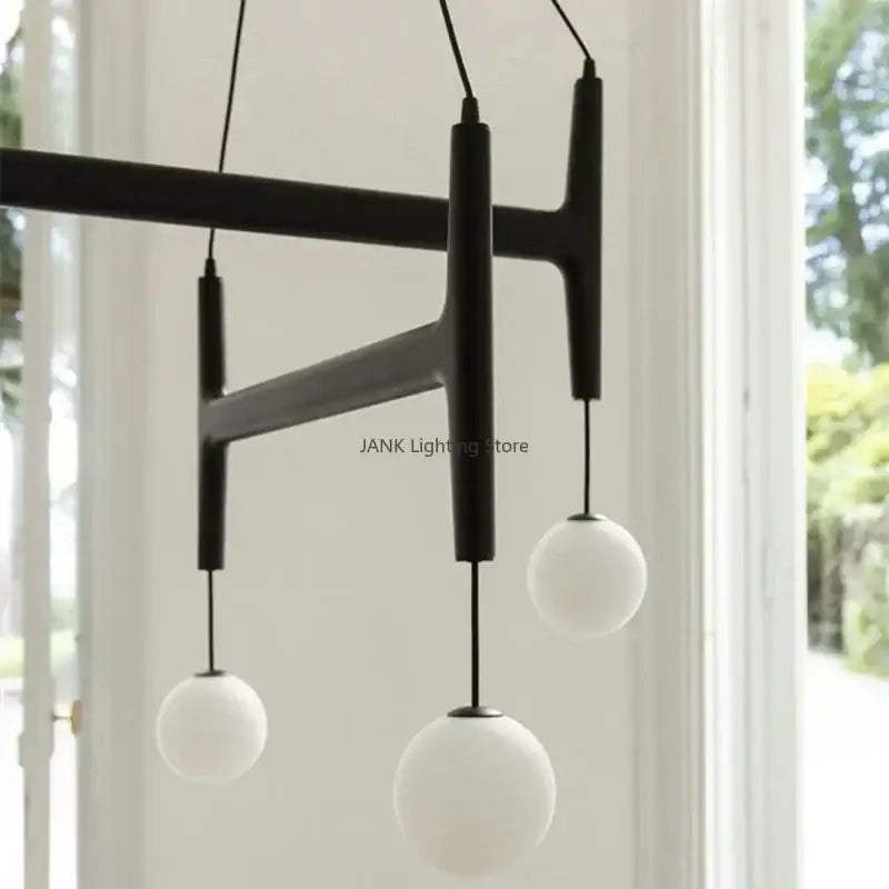 Black matte decorbites astra wood pendant chandelier with three white glass globe lights for interior decor