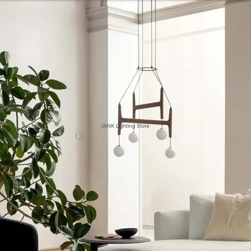 Modern geometric decorbites astra wood pendant light with dark wood frame and five white glass LED bulbs