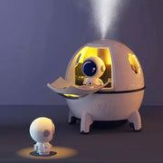 White decorbites astronaut air humidifier night light with dome-shaped body and glowing yellow interior for kids