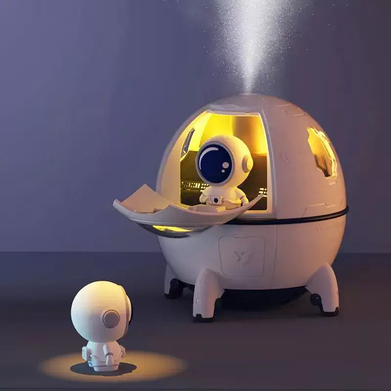White decorbites astronaut air humidifier night light with dome-shaped body and glowing yellow interior for kids