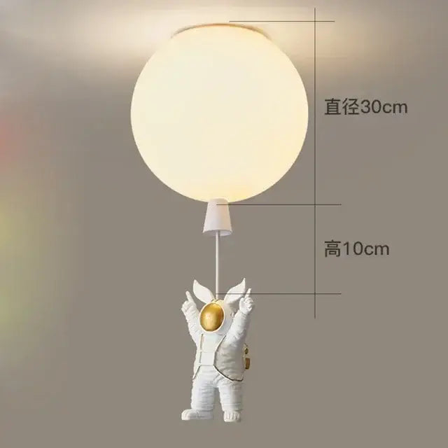 White astronaut figurine holding glowing spherical light in DecorBites astronaut balloon ceiling LED chandelier lamp