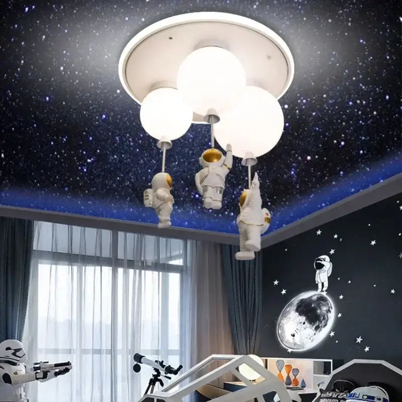 White DecorBites astronaut balloon ceiling lamp with three spherical bulbs and dangling astronaut figurines for kids room