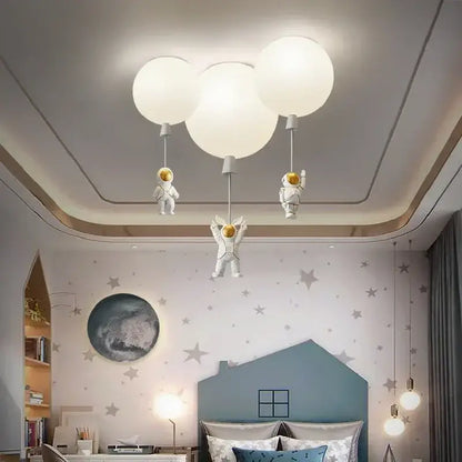White decorbites astronaut balloon ceiling lamp featuring balloon-shaped LED light with hanging astronaut figurines