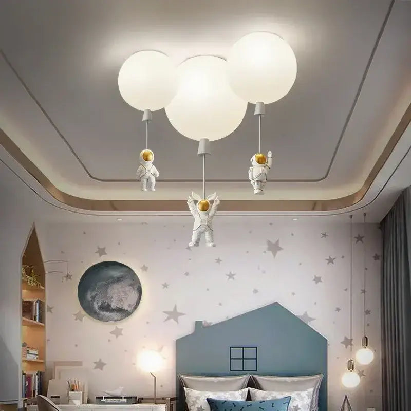 White decorbites astronaut balloon ceiling lamp featuring balloon-shaped LED light with hanging astronaut figurines