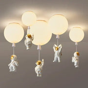 Decorbites astronaut balloon led pendant light featuring white astronaut design with gold accents and spherical globe shades for nursery room