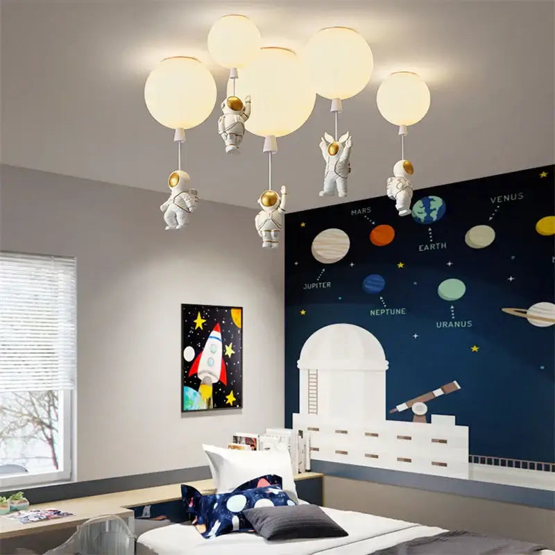 White DecorBites astronaut balloon pendant light with spherical globe bulbs and detailed figurines for nursery room