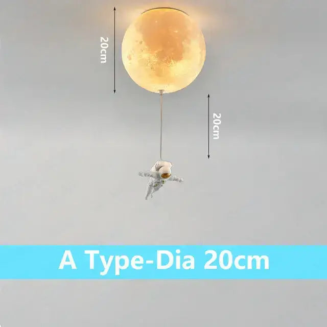 A glowing 20cm moon-shaped ceiling light with a dangling astronaut figure in the DecorBites astronaut bubble chandelier