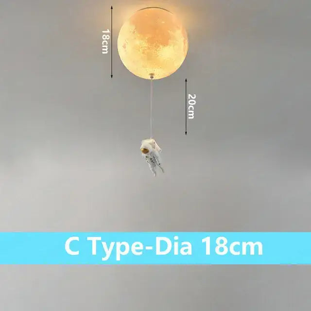 A warm glowing spherical moon-shaped lamp with a white astronaut figurine dangling by a thin cord decorbites astronaut bubble chandelier light