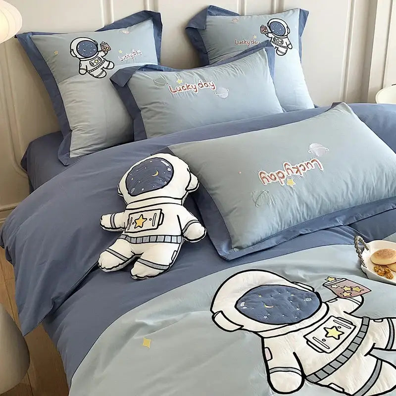 Blue cotton bedding set with astronaut cartoon embroidery and plush toy by decorbites for boys single bed