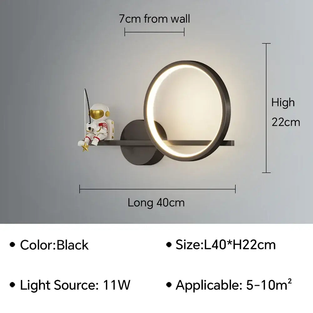Black circular led wall lamp with metallic frame and illuminated ring featuring decorbites astronaut cartoon figurine arm mount