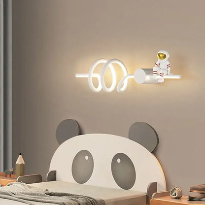 White spiral led wall lamp with a miniature astronaut cartoon figurine by DecorBites astronaut cartoon for modern decor