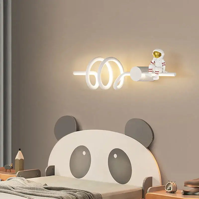 White spiral led wall lamp with a miniature astronaut cartoon figurine by DecorBites astronaut cartoon for modern decor