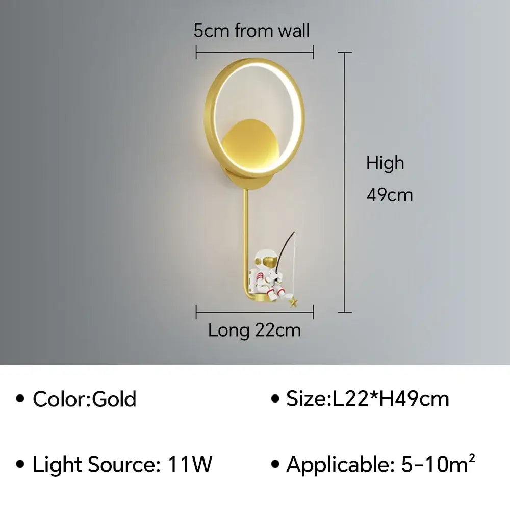 Gold-colored modern wall lamp with circular LED ring and hanging astronaut cartoon figurine decorbites astronaut cartoon