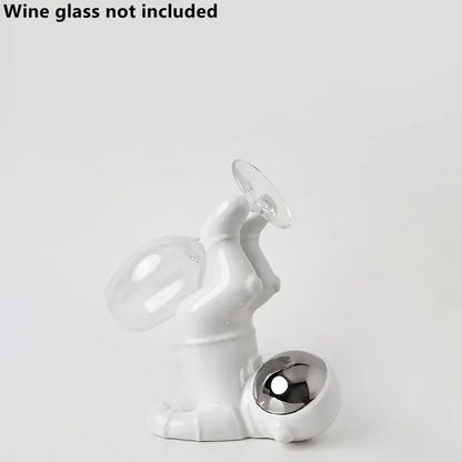 White ceramic astronaut ceramic wine rack figurine holding wine glass with metallic sphere base by decorbites