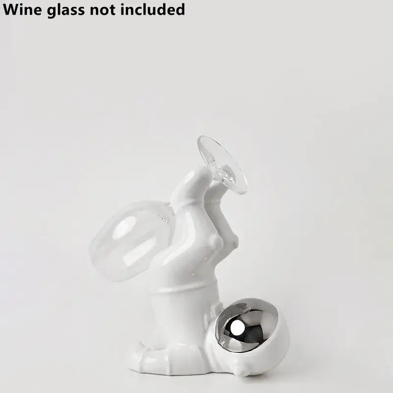 White ceramic astronaut ceramic wine rack figurine holding wine glass with metallic sphere base by decorbites
