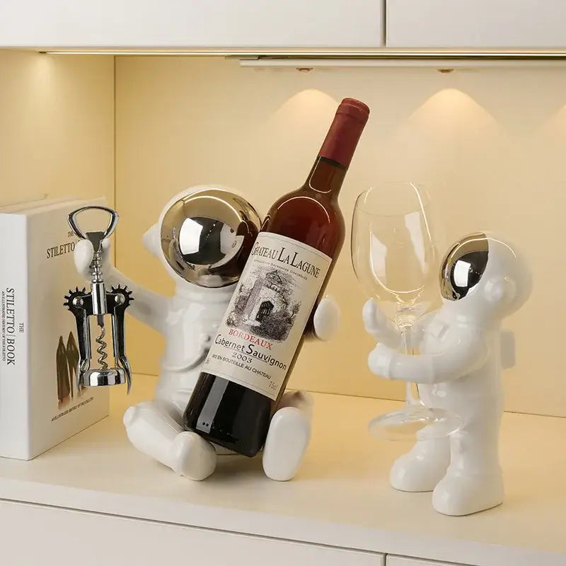 Decorbites astronaut ceramic white figurines with silver helmets function as an astronaut ceramic wine rack and bar accessory