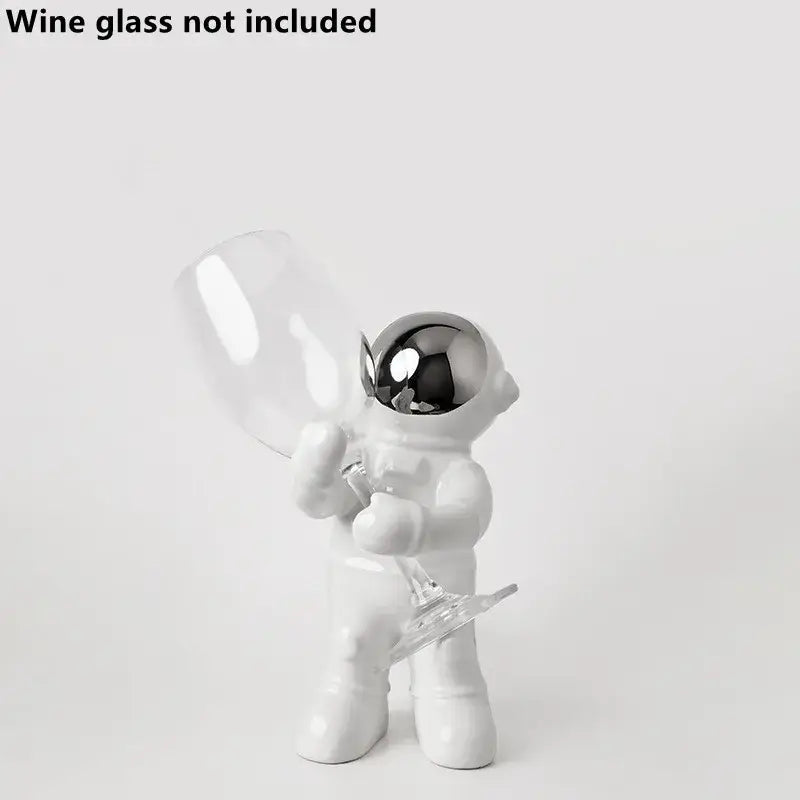 White ceramic astronaut figurine with reflective silver helmet holding a clear wine glass for decorbites astronaut ceramic wine rack