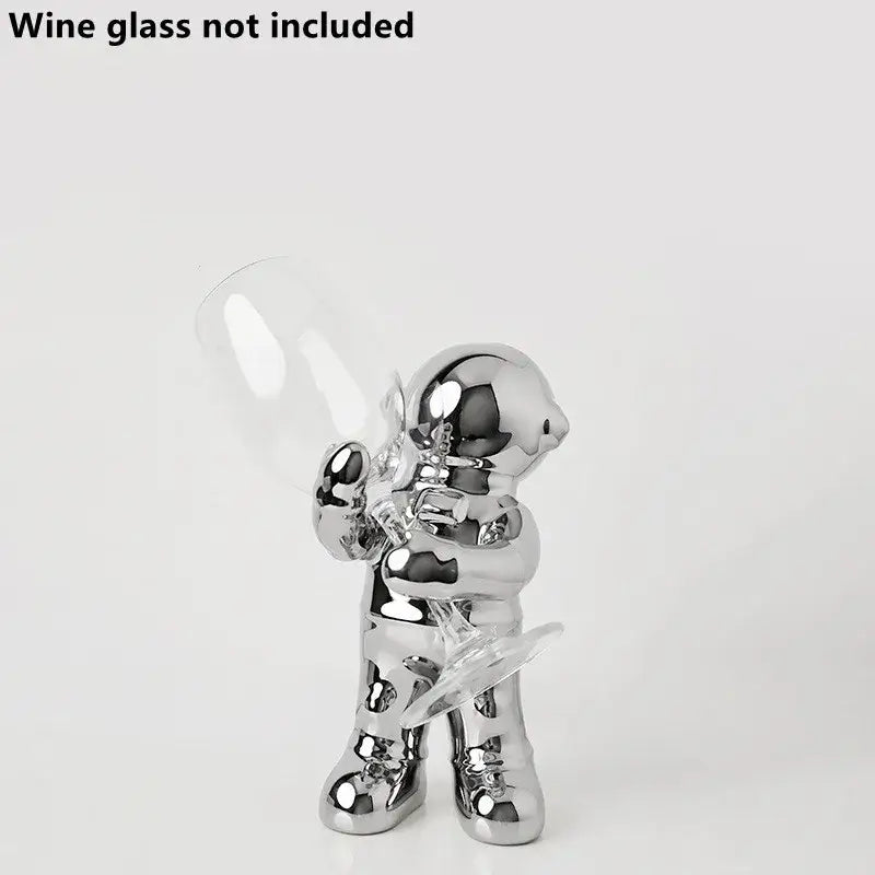 Shiny chrome decorbites astronaut ceramic figurine holding clear wine glass for a unique astronaut ceramic wine rack