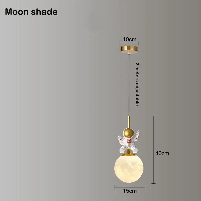 Whimsical gold-toned decorbites astronaut chandelier featuring an astronaut figurine on a glowing moon pendant light