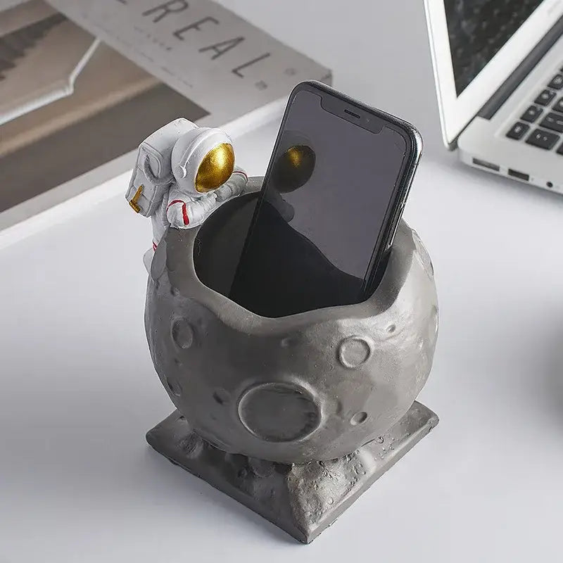 Decorbites gray astronaut-themed pen holder figurines with white and gold-suited figure on moon-like surface for desk decor