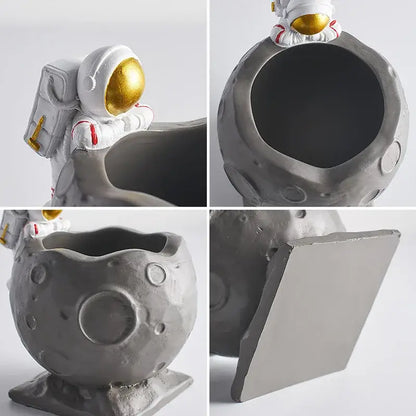 Gray moon-shaped resin pen holder figurines with white astronaut featuring gold visor and red accents for desk decor