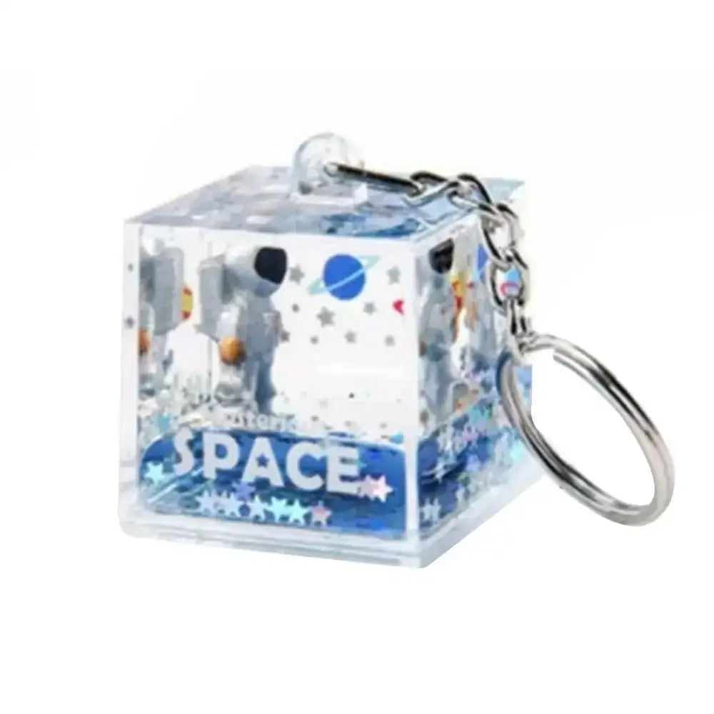 Clear cube keychain with liquid-filled resin and space-themed astronaut drift design from decorbites astronaut drift collection
