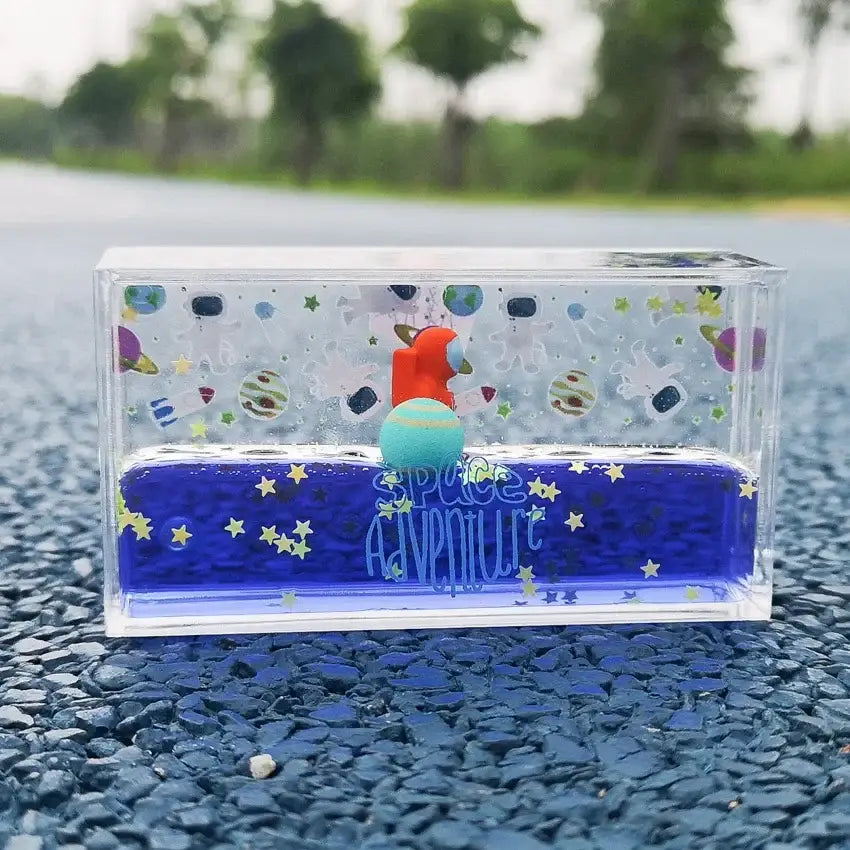 Clear resin decorbites astronaut drift keychain with blue liquid space scene and orange astronaut figurine for stress relief