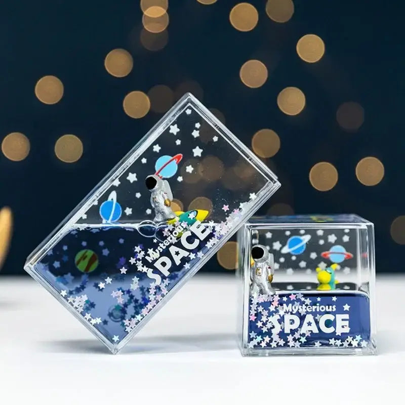 Clear rectangular resin keepsake boxes with miniature astronauts planets and stars in liquid interior for decorbites astronaut drift keychain