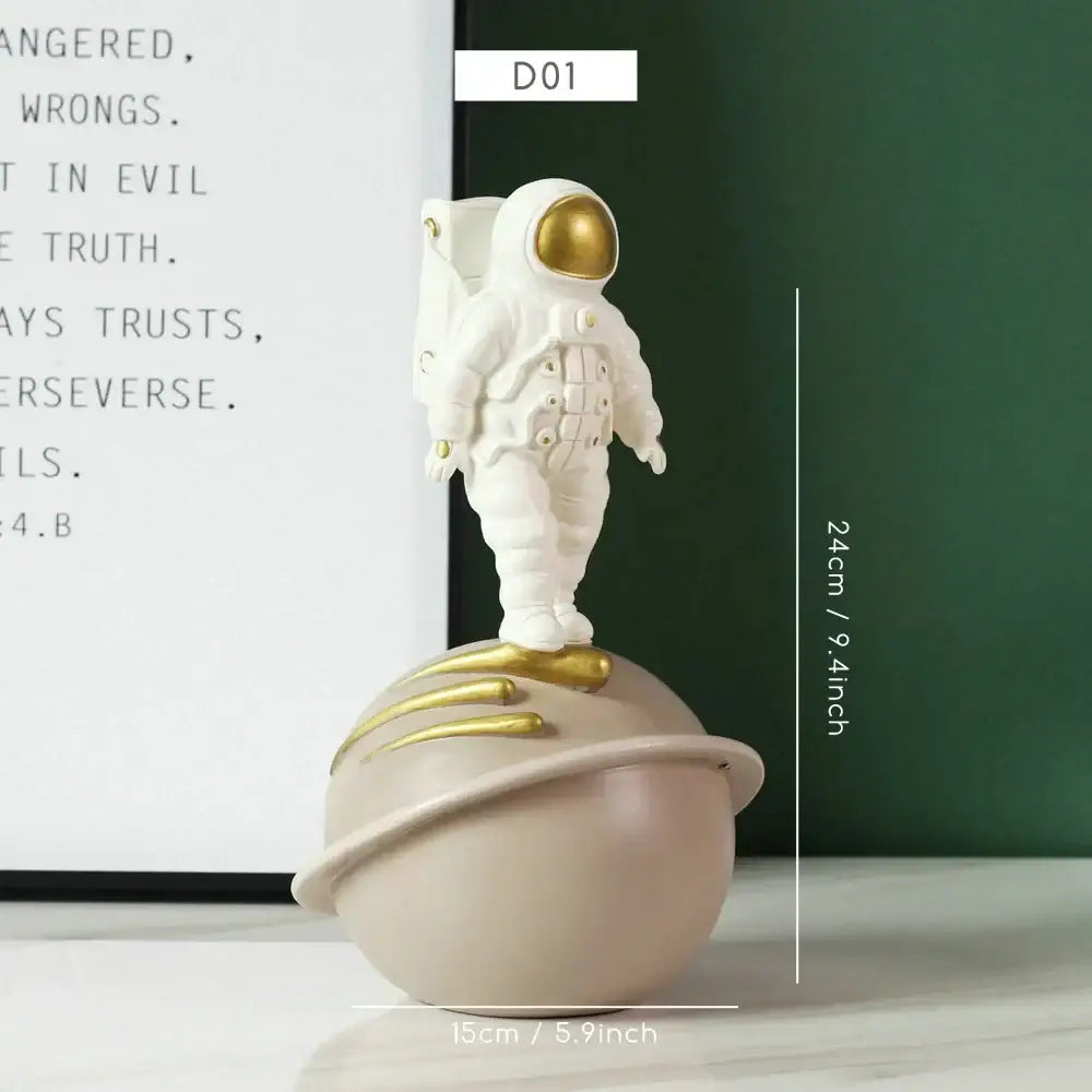 DecorBites astronaut figurine abstract sculpture in white with gold accents standing on a beige planet with golden rings
