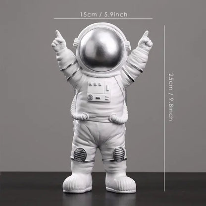 A sleek silver-toned decorbites astronaut figurine abstract sculpture with a glossy helmet and detailed suit for modern decor