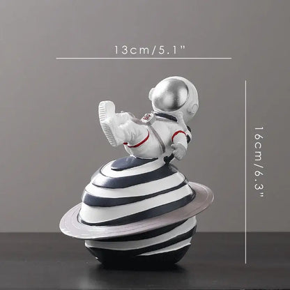 Decorbites astronaut figurine abstract sculpture in white with silver helmet and red accents on striped planet base for decor