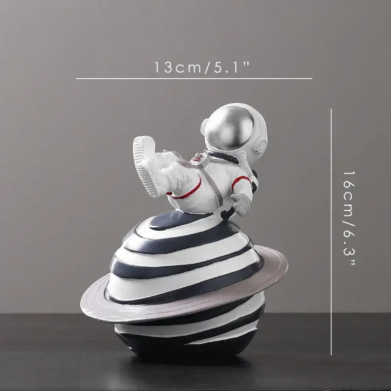 Decorbites astronaut figurine abstract sculpture in white with silver helmet and red accents on striped planet base for decor