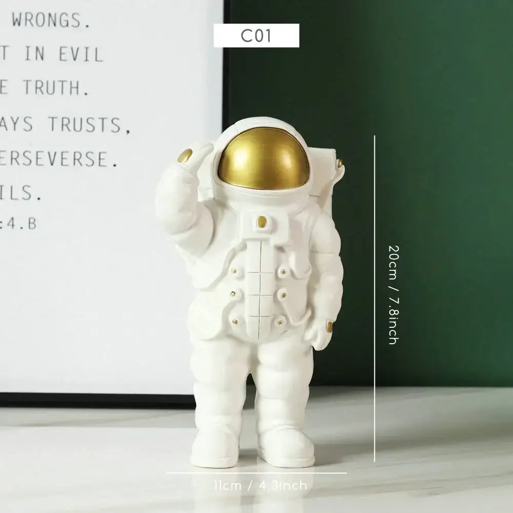 Decorbites astronaut figurine with gold helmet and metallic accents in a saluting pose for modern home decor