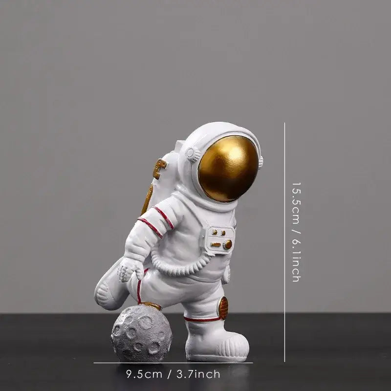 White astronaut figurine with gold visor and red trim standing on textured gray moon surface by decorbites astronaut figurines