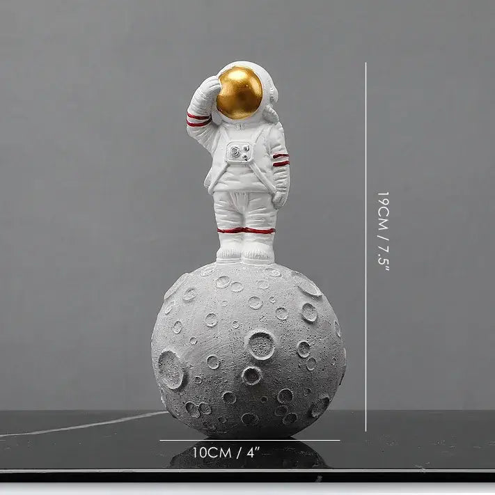 White astronaut figurine with gold helmet on textured gray moon base from decorbites astronaut figurines collection