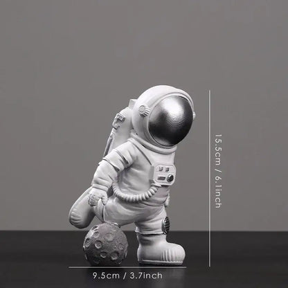 White astronaut figurine with metallic silver helmet on textured gray moon surface from decorbites astronaut figurines