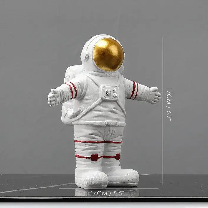 White astronaut figurine with gold visor and red accents in welcoming pose from DecorBites astronaut figurines collection