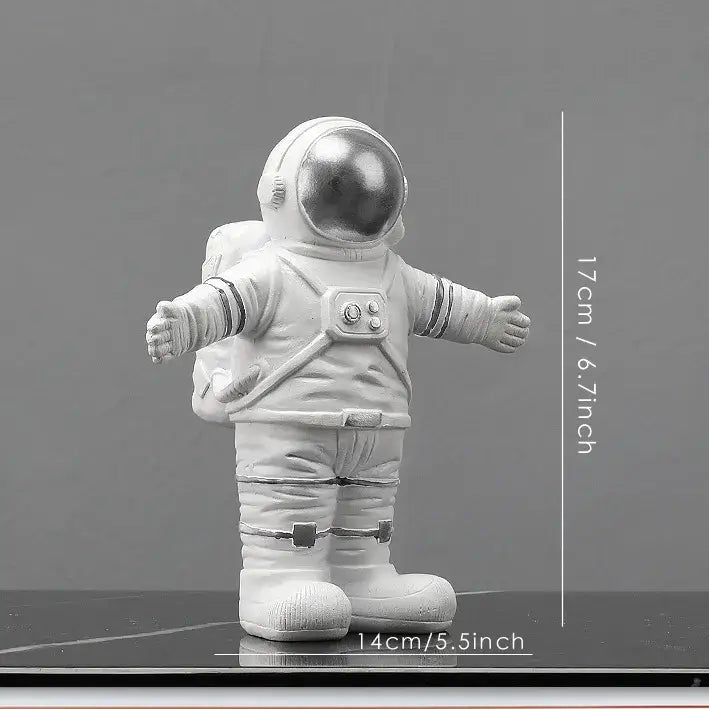 White astronaut figurine with reflective silver helmet and detailed suit on dark surface from decorbites astronaut figurines collection