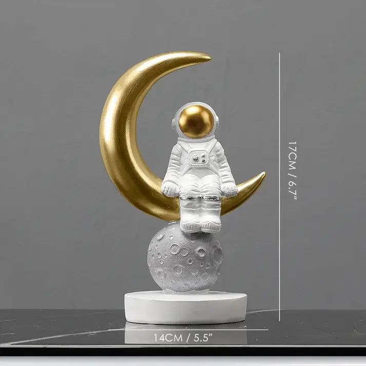Decorbites astronaut figurines white spaceman with gold helmet seated on textured gray moon beneath golden crescent moon