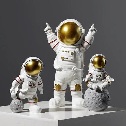 White decorbites astronaut figurines with gold helmets and accents in detailed space suits, ideal gift for man and boyfriend