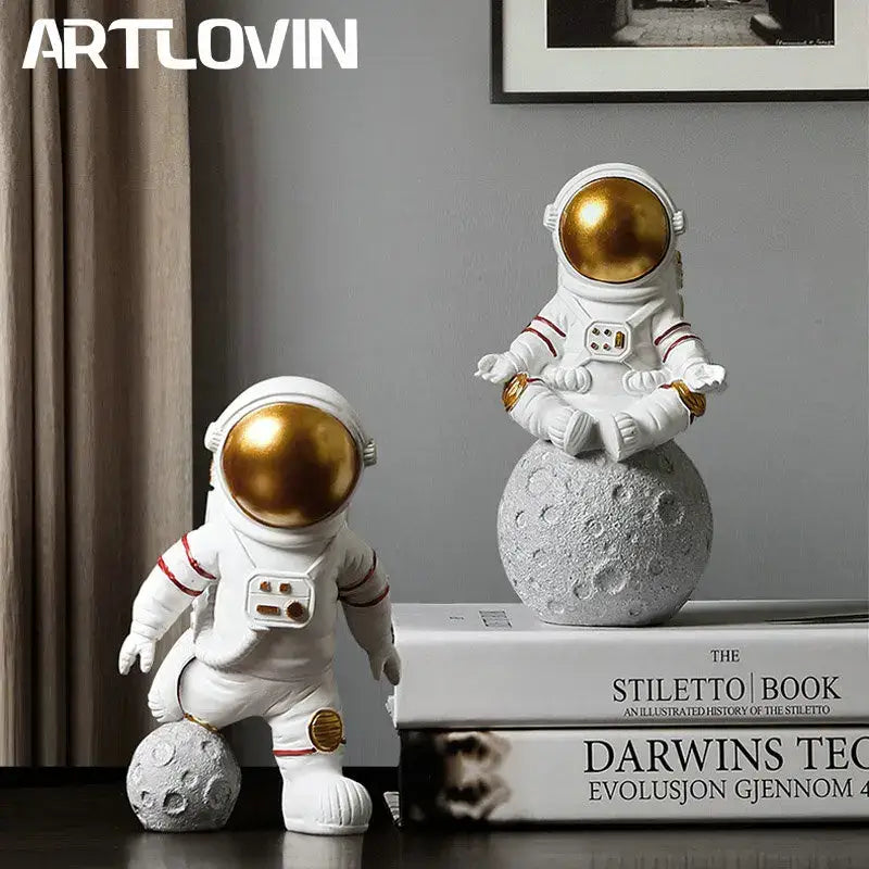 White astronaut figurines with gold helmets and moon base detail in decorbites astronaut figurines gift sculpture