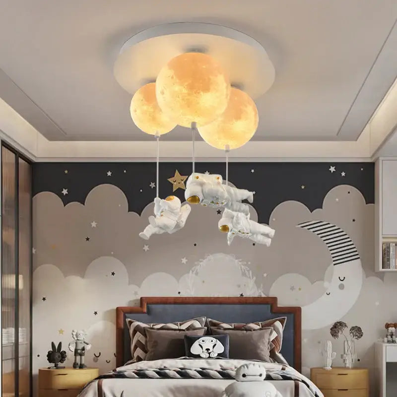 Whimsical decorbites astronaut globe ceiling light featuring three glowing yellow moons and floating white astronauts for kids room