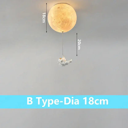 A warm illuminated DecorBites astronaut globe ceiling light with detailed craters and dangling astronaut figurine for kids room