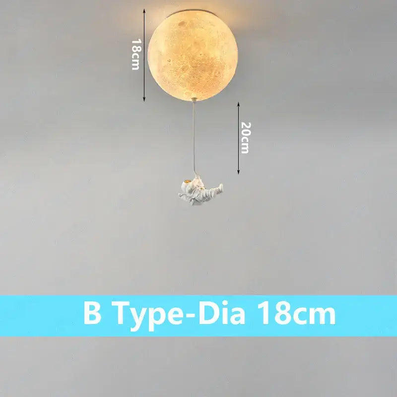 A warm illuminated DecorBites astronaut globe ceiling light with detailed craters and dangling astronaut figurine for kids room