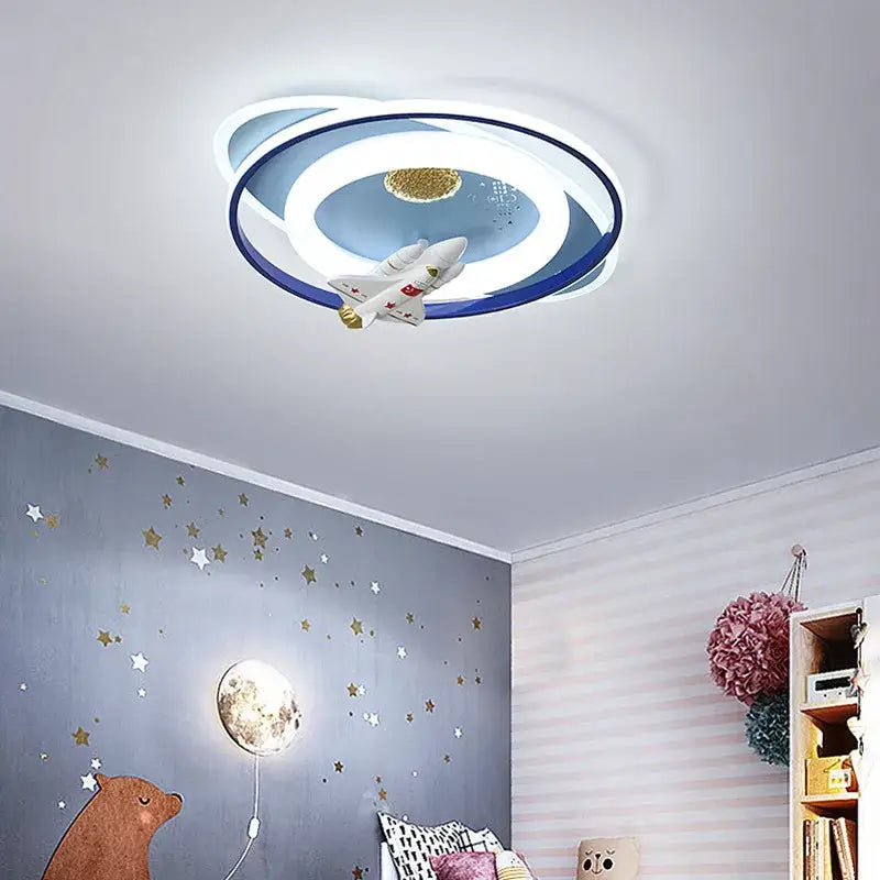 Modern ceiling light fixture with blue and white rings, golden planet disc, and spaceship for DecorBites astronaut kids bedroom