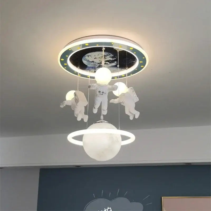 DecorBites astronaut led ceiling light featuring three white astronaut figures above glowing moon with planet backdrop