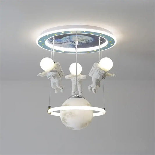 Decorbites astronaut led ceiling light featuring three white astronaut figurines glowing above a ringed planet