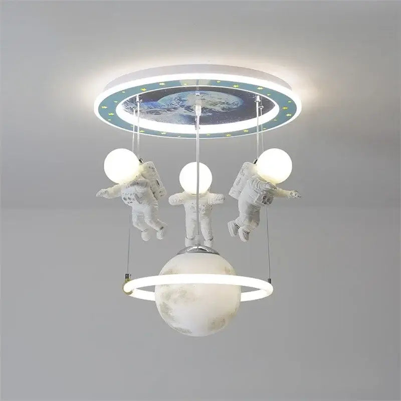 Decorbites astronaut led ceiling light featuring three white astronaut figurines glowing above a ringed planet